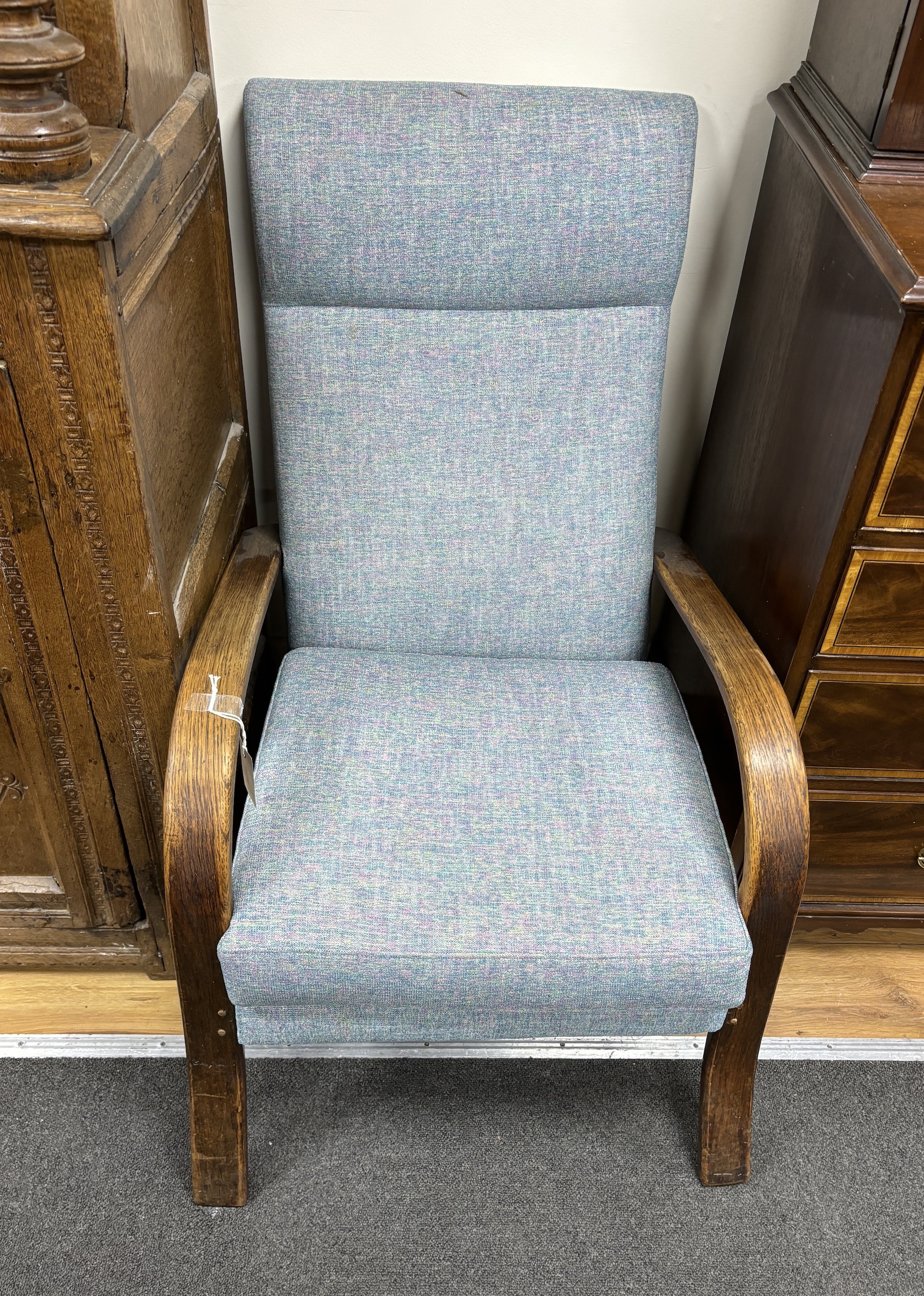 A mid century oak armchair, recently re-upholstered, width 58cm, depth 75cm, height 92cm